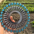 Macro shot of a metal round pendant with blue faceted gemstones and intricate bead details - Retro Silver Light Blue Rhinestone
