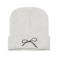 Close-up of white knit beanie featuring detailed black embroidered bow and ribbed cuff - M (56-58cm) / Beige