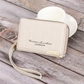Detail of beige zipper wallet with woven texture, metal hardware and wrist strap - Off White