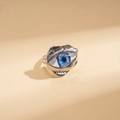 Close-up of irregular silver ring featuring a detailed blue evil eye resin inlay - Silver
