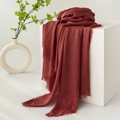 Linen blend scarf in dark red with fringe details draped over a white cube base - Dark Red