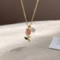 Elegant gold chain necklace with pink tulip flower pendant and white pearl detail - Gold