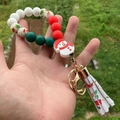 Close-up of Christmas silicone beaded keychain with snowman charm and red festive tassel - Snowman Character Pendant with Red Print Tassel (Style 5)