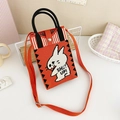 Borsa a tracolla in maglia arancione con design a coniglio e manico nero su tavolo - 1-Coniglio Arancione-SHUT UP!