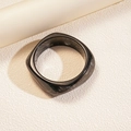 Macro shot of geometric resin square bangle with black marble texture and polished finish - Black