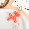 Balloon dog keychain with orange and pink gradient metallic finish and golden lobster clasp - Iridescent Orange Red