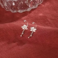 Silver lotus earrings with tassel pendant displayed on elegant red fabric background - Lotus Tassel Pendant Style (A84)