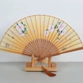Japanese style golden folding bamboo fan with pink cherry blossoms and brown tassel decoration - Carbonized Ribs Style 36
