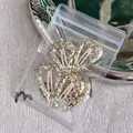 Set of two gold glitter heart snap hair clips in transparent packaging on grey fabric - Gold Heart