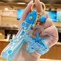 Blue ocean-style floating liquid keychain with starfish glitter and cherry blossom pendant - Blue