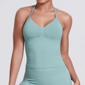 Detail view of seamless light mint green V-neck sports bra and high-waisted leggings set - Pale Green