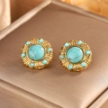Detailed macro view of bohemian vintage 18K gold earrings with turquoise and pearl inlays - Gold + Lake Blue Turquoise