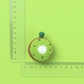 Handmade crochet kiwi slice keychain charm in green yarn with measurement scale - Kiwi Fruit Slice Doll