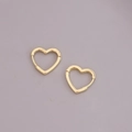 Detail of 18K gold heart-shaped geometric hoop earrings on a light purple background - Small Heart Pendant / Gold