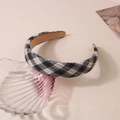 Close-up of black and white plaid fabric headband with a stylish retro sponge padded design - Black & White Check
