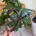 Detail of dark gray translucent shark hair claw clip with golden metal spring - Transparent Black