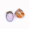 Detail view of the hammered gold band and oval pink gemstone with sparkling side stones - Rose Quartz