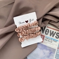 Set of 3 champagne gold satin scrunchies with smooth silk texture on neutral background - Rose Pink
