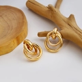 Polished golden triple interlocked geometric hoop earrings in a minimalist style - Interlocking Triple Rings