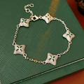 Detailed view of silver clover bracelet with five green gemstones on leather box - Silver-Green