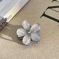 Off-white floral hair claw clip with golden base and central crystal rhinestone - Blue Gradient