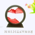 Moving sand art piece with red sand and black circular frame for desktop decor - 5 Inch Round Red