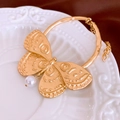 Minimalist gold-plated butterfly bracelet with a white pearl charm on a ceramic plate - Gold Embossed Butterfly Pearl Style