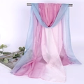 Close-up of lightweight gradient pink and blue chiffon scarf draped over a metal bar - Blue Pink