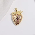 Detailed macro view of a golden strawberry pendant with pink gemstones on white surface - VD1655 Gold Rose Red Zircon Strawberry