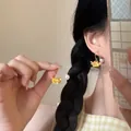 Close-up of floral tassel earrings with yellow flowers and white pearl on a gold hook - 16# Ear Hook - Yellow