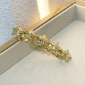 Elegant gold star-shaped spring hair clip with polished finish on a beige jewelry tray - Star Gold