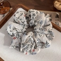 Detail of Chinese ink calligraphy on beige chiffon scrunchie over wooden tray - Poetry & Calligraphy (Black Ink)