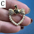 Detail of a heart-shaped pearl pendant with a gold bow and cubic zirconia accents - Style C-Bow Heart