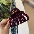 Detailed view of glossy dark purple resin hair claw clip with strong golden metal spring - Cherry Red