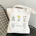 Off-white canvas tote bag featuring colorful wildflower garden illustration print - C9 Wild Flowers Typography