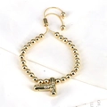 Detail of adjustable gold bead bracelet with crystal-studded letter T charm - Letter T