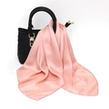 Close-up of a pink satin square scarf draped elegantly on a textured black leather handbag - One Size / Faux Silk Satin / Pink