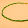 Macro shot of green faceted crystal beads and gold metal spacers on a handmade necklace - GX03167D (Green Faceted Beads with Gold Spacers)