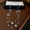 Detailed view of double-layered gold-plated necklace with elegant white pearls on velvet - Double Layer Style / Silver (Real Gold Plated)