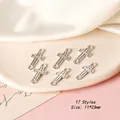 Macro detail of silver cross jewelry connectors, 11x23mm DIY earring charms with dual rings - Cross Style 17 / Antique Silver