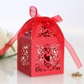 Elegant red laser-cut wedding favor box with heart patterns and a matching red satin bow - Pearlescent Red