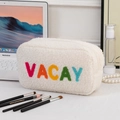 White plush cosmetic travel bag with colorful VACAY embroidery and top zipper closure - VACAY Embroidery Style