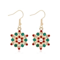 Gold snowflake drop earrings with colorful rhinestones and pearl center on white background - Colorful Rhinestone Snowflake