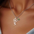 Silver necklace with green gemstone and floral pendant worn on a female model - August