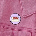 Detailed close-up of a Scream Queen horror movie pin on a pink denim jacket - Bloody Cake (XZ8901)
