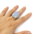 Detail of handmade wire-wrapped tree of life ring with oval opal gemstone on finger - Adjustable Open / Oval Opal