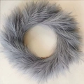 Round faux fur wreath in soft grey color with fluffy texture on minimalist beige background - Light Gray