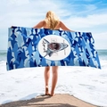 Detail of a microfiber beach towel featuring a shark print and eco-friendly slogans - Shark Save the Ocean