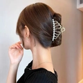 Golden crown hair claw clip with pearl embellishments worn on brown hair - Crown
