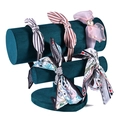 Three-tier green velvet headband display stand holding assorted stylish hair accessories - Heart-Shaped Headband Stand / Dark Green
